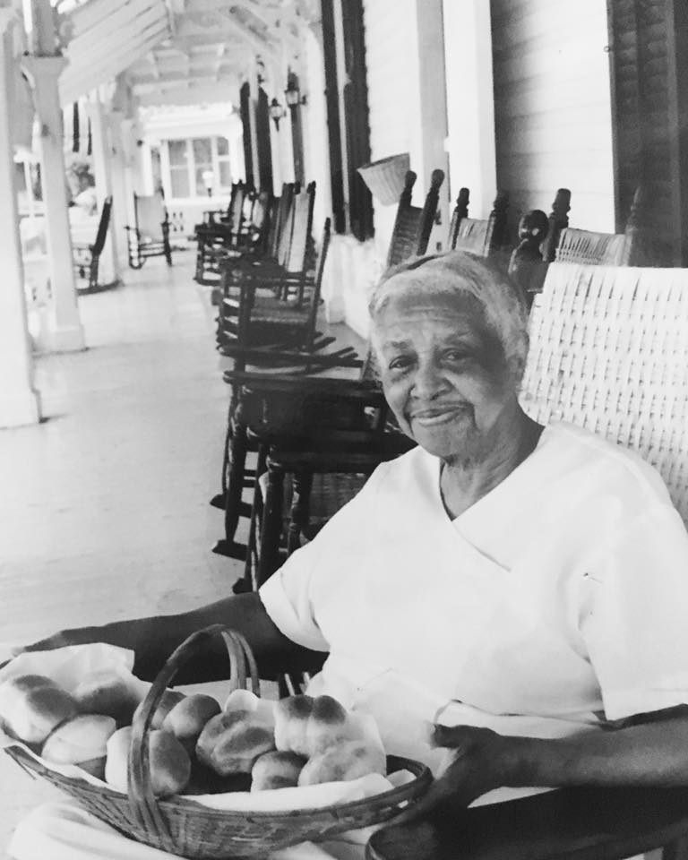 Helen sitting on the porch with a basket of bread